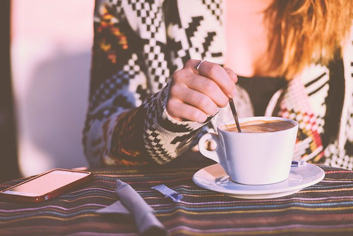 Woman's hand stirring coffee