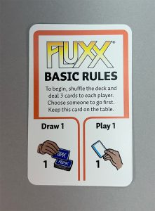 The Basic Rules card decrees the opening rules of the game: on a turn players will (a) Draw one card and then (b) Play one card.