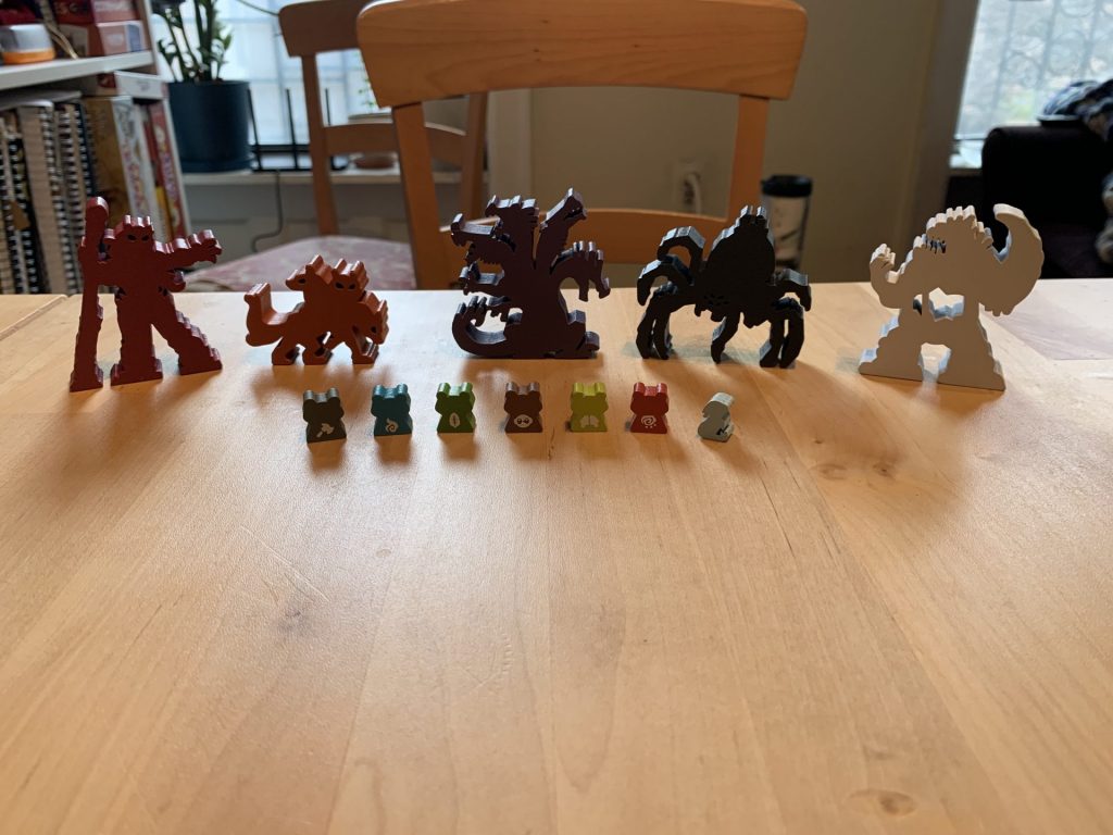 All of the meeples arranged on a table.