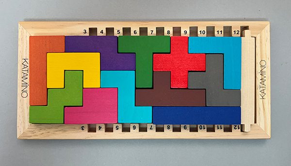 The twelve Pentominoes in the Katamino wooden frame.