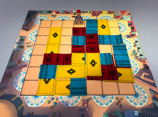 Part-way through a three-player game. Notice how many carpets have been completely or partially covered by other carpets.