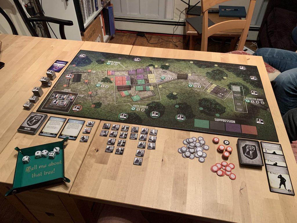 The board set out on a table with all the components surrounding