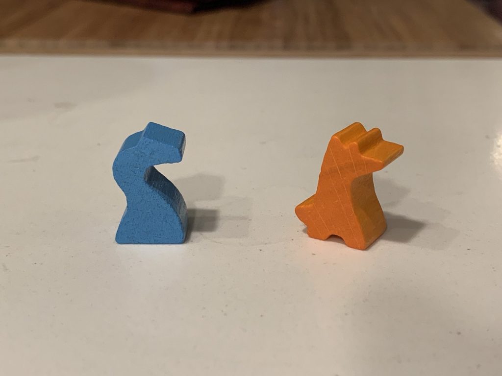 A blue wooden snake and an orange wooden fox.