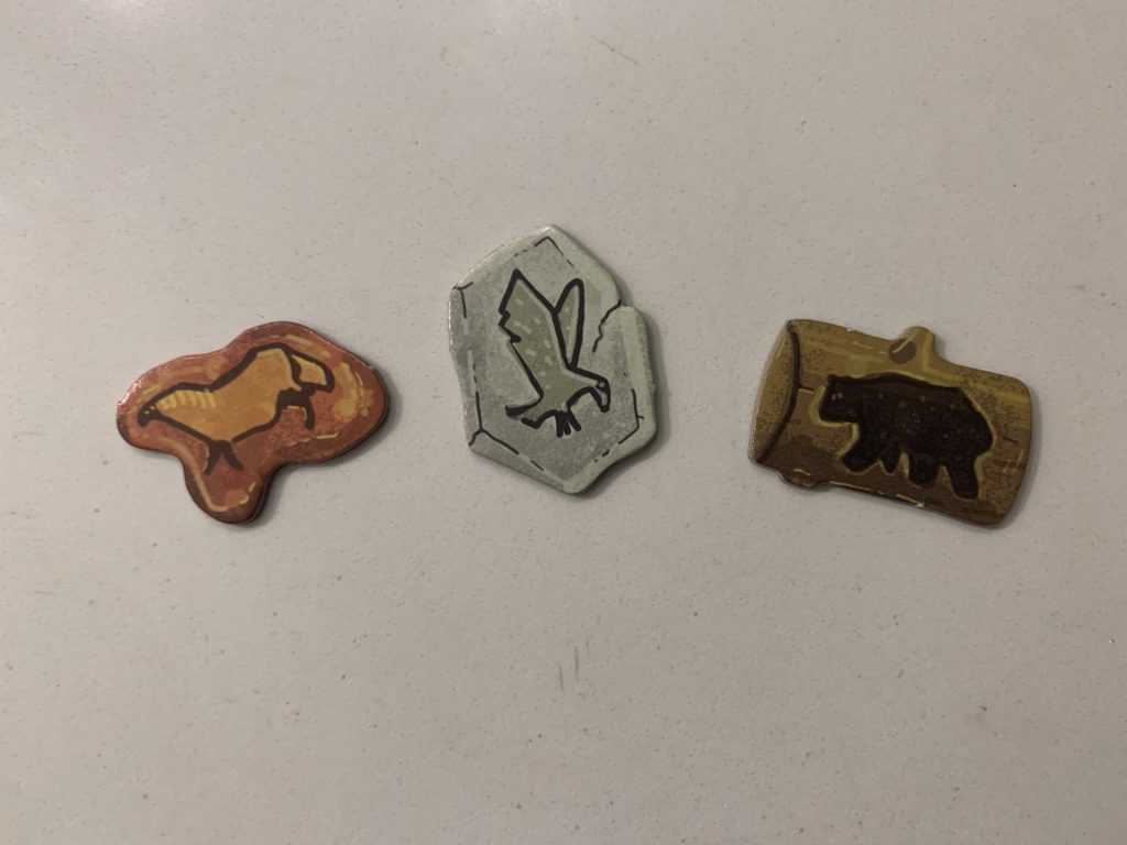 The horse, hawk, and bear tokens, each designed to resemble a cave painting.