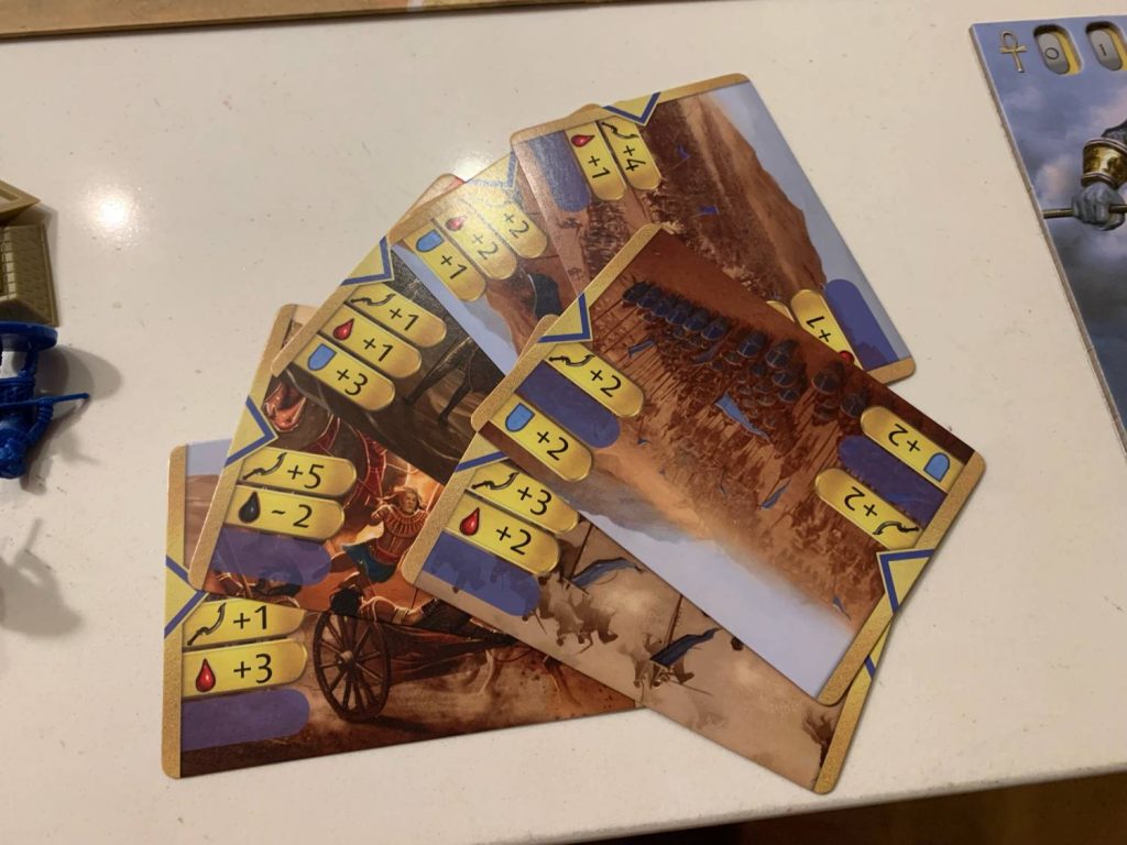 The eight combat cards laid out on a flat surface.