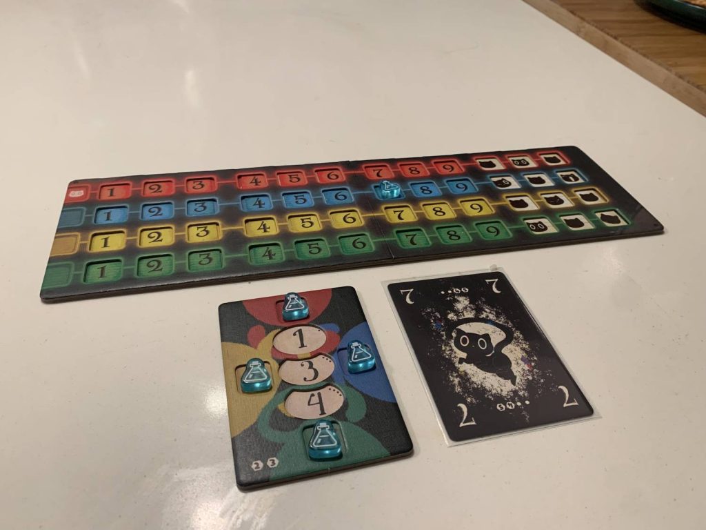 A player board with a 7 card to the right side, indicating it has been played as a blue 7. A player token has been placed on the corresponding spot of the central board.