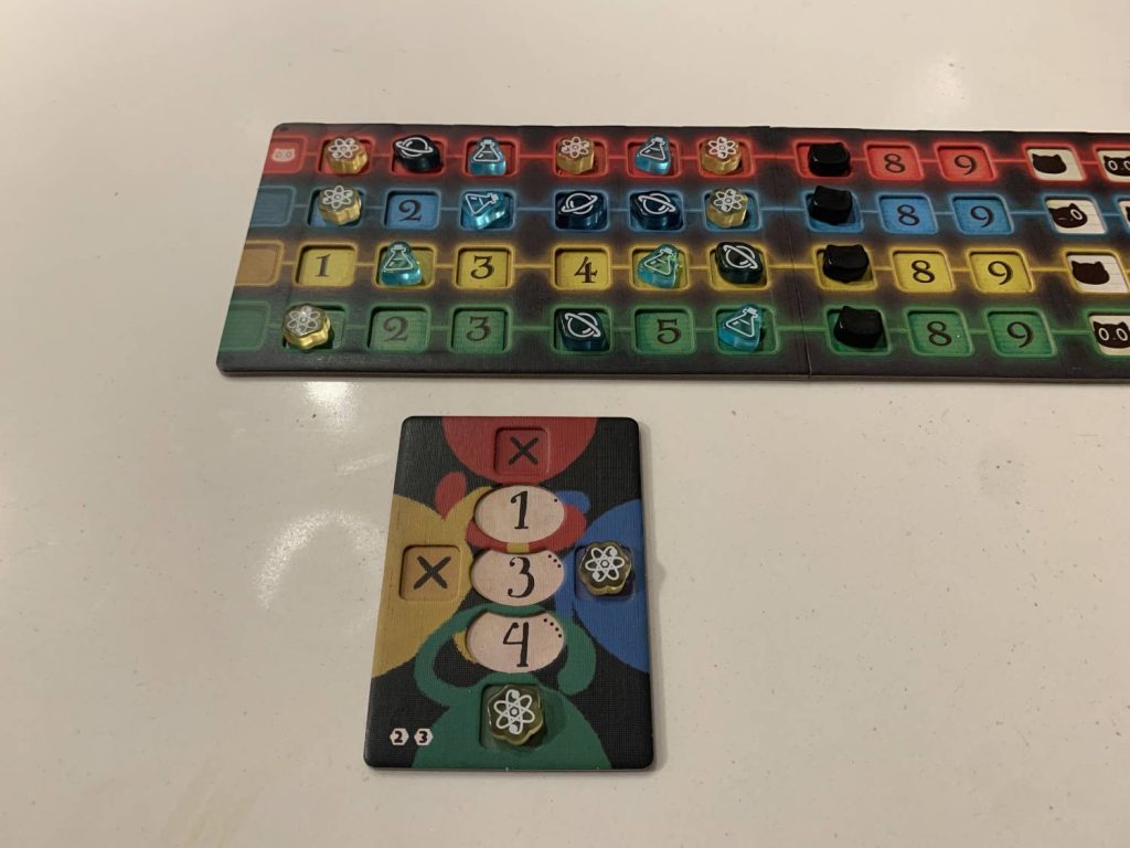 A player board with tokens removed from the upper and left locations, meaning that player can no longer observe red or yellow cards.
