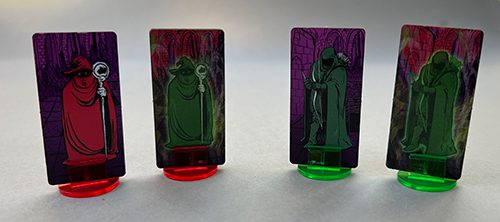 Adventurer Standees. The darker colored standee (on the left) is for the living Adventurer; the greenish glowing character standee is used should they become Wraiths.
