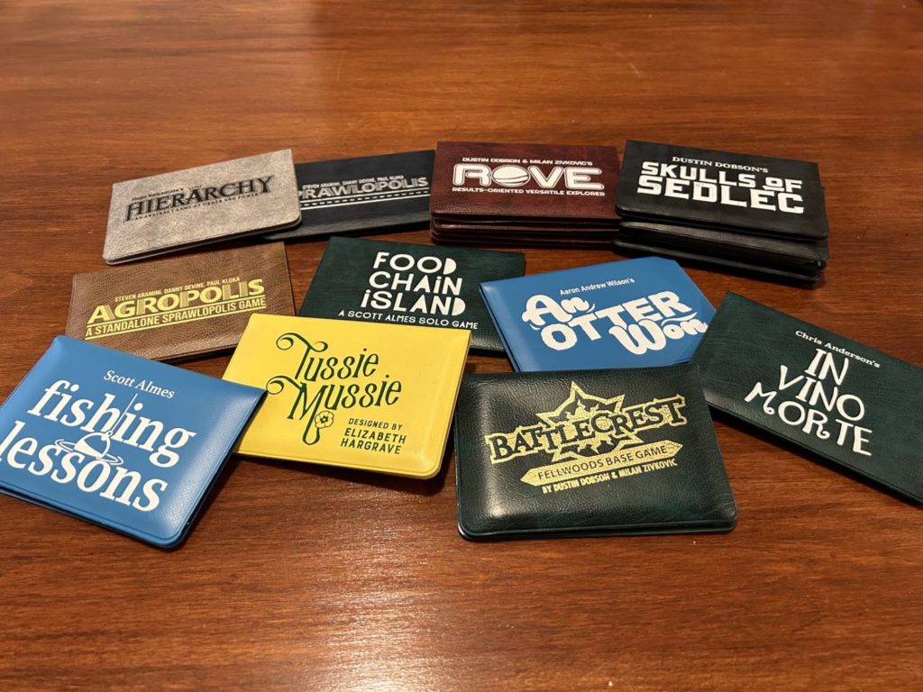 A collection of pocket-sized wallets strewn about on the surface of a table.