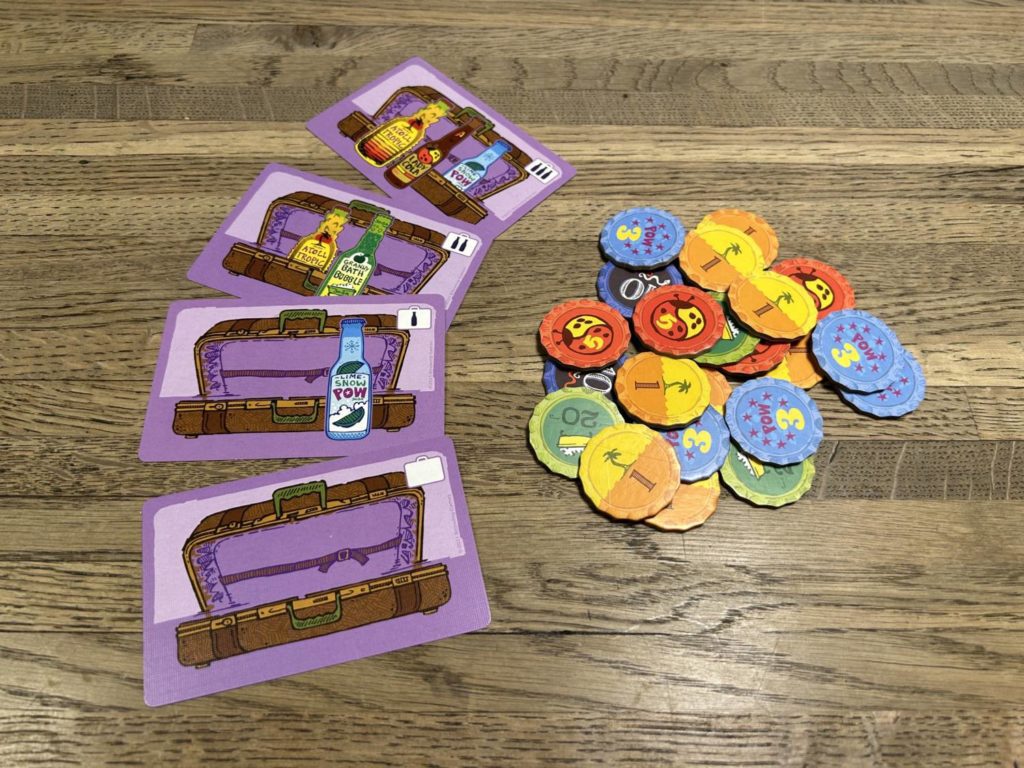 A pile of bottle caps next to four suitcase cards, containing from zero to three bottles of soda.