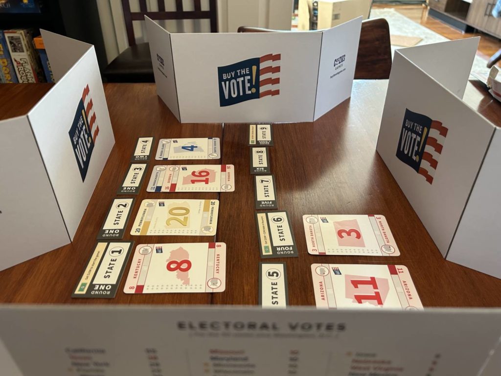 The card market for Buy the Vote!, surrounded by four player privacy screens.
