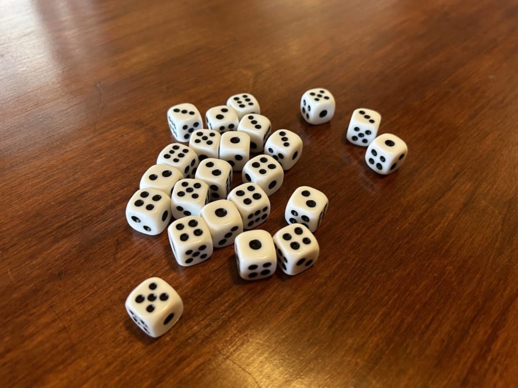 A collection of dice from the game, with irregular pips.