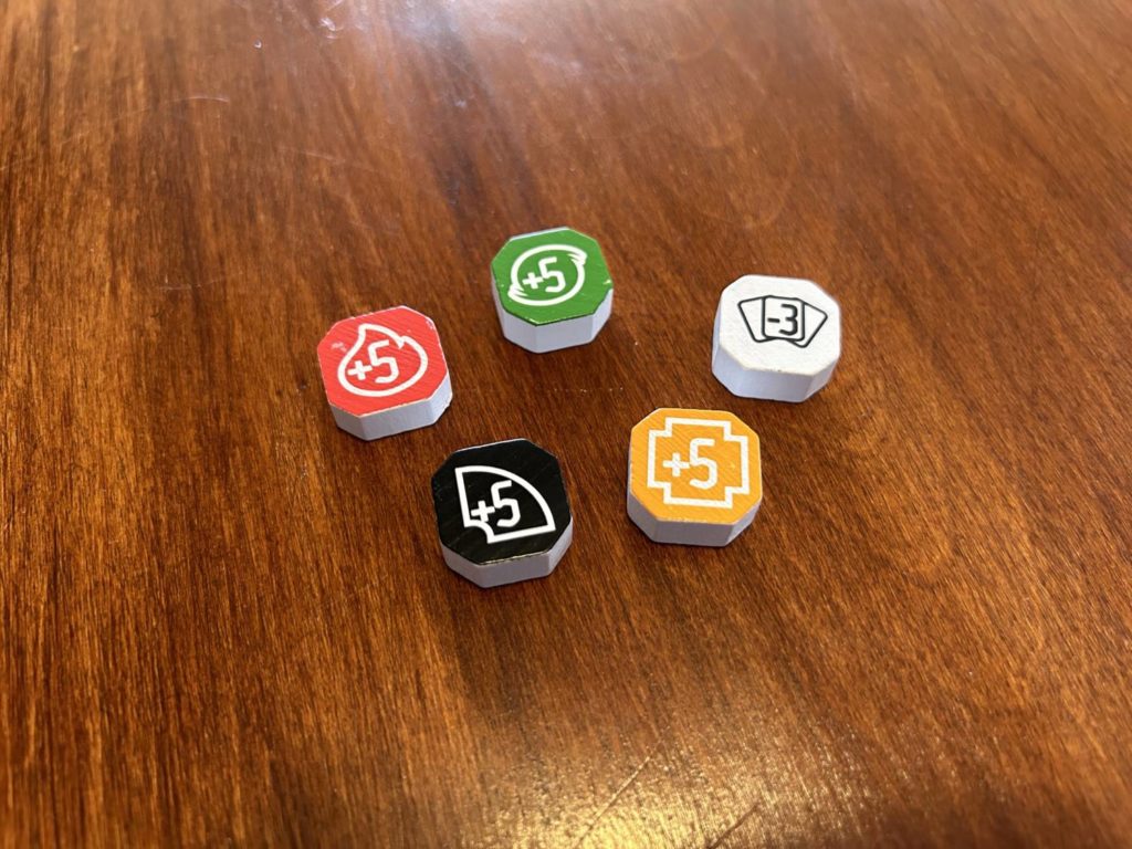 Five bonus tokens on a table.