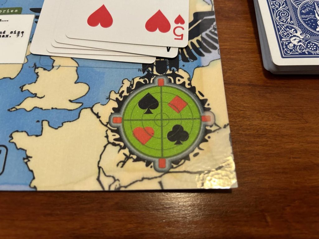A rondel with the four suits of a deck of cards. If there are no spaces available for a German card you reveal, you treat the card as though it were the suit clockwise from the original suit.