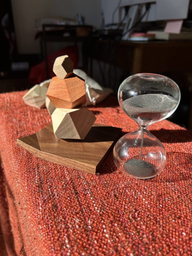 Three of the wooden pieces stacked atop one another, with the timer running down next to them.