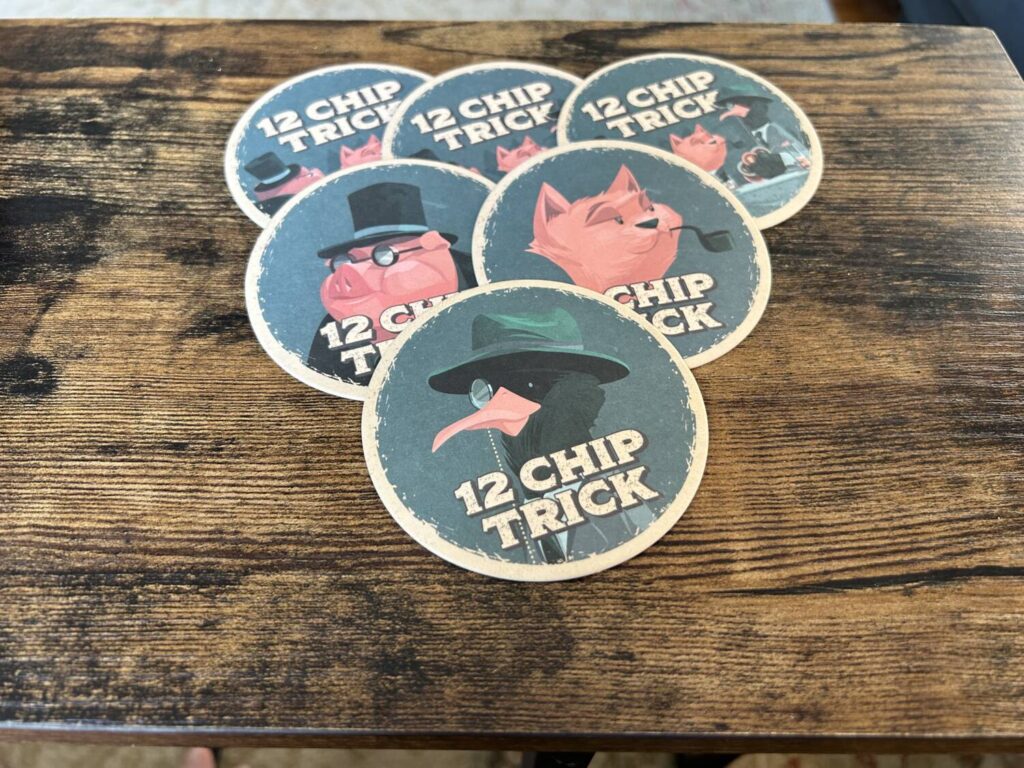Six coasters laid out in a pyramid, with illustrations of an anthropomorphized pig, cat, and sea bird.