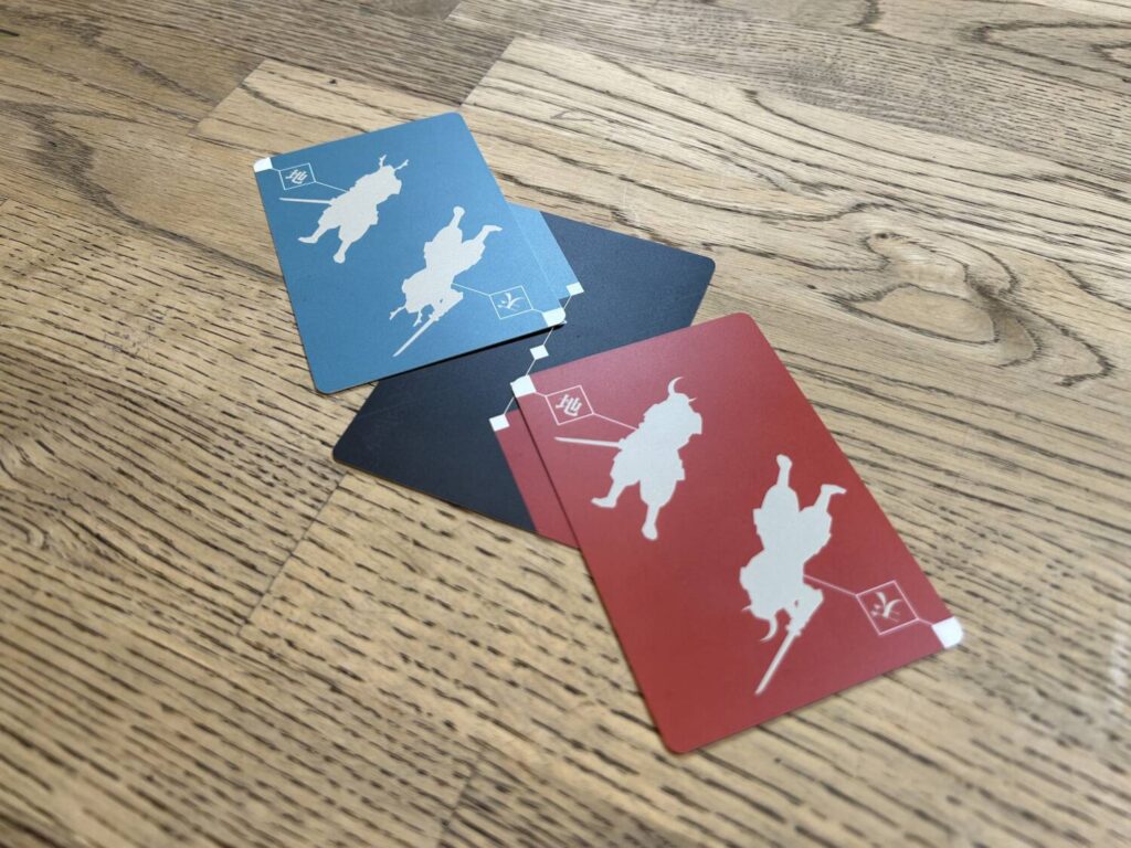 The two Samurai cards on the battle field, a straight line of five spaces.