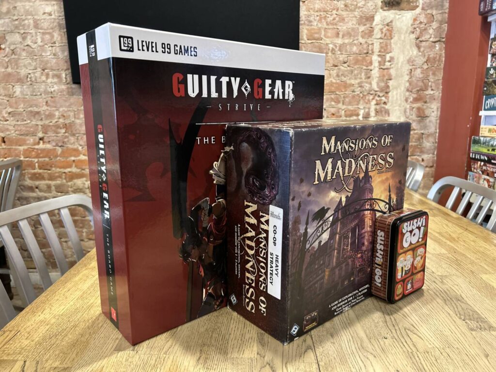 The box for Guilty Gear: Strive - The Board Game next to a comparatively itty-bitty Mansions of Madness.