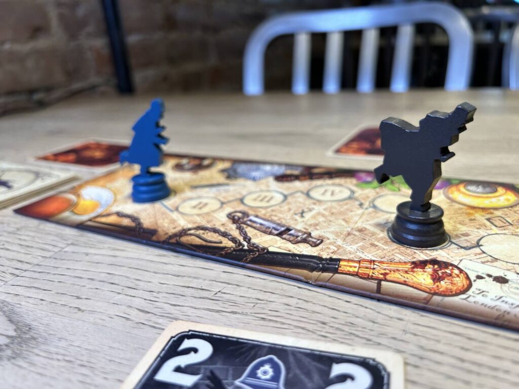 A close-up shot of the two wooden pawns on the board. They are dynamically designed, giving the impression of a footchase.