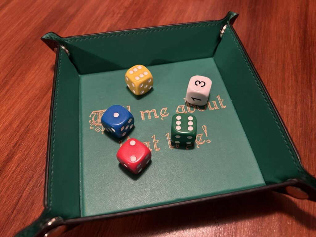 The five dice used for the game, each of which is a different color.