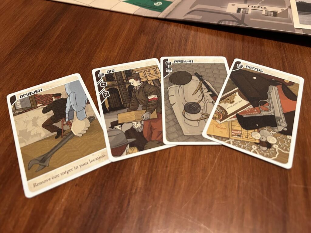 Four of the player cards, each of which features an illustration of a resistance fighter and one-to-three icons in the upper left corner.