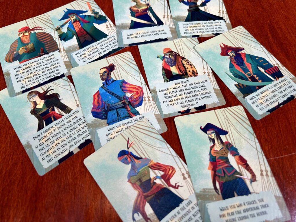 There are numerous captain cards in the box, each with a different power. In this photo, you see a group of them spread out on the table.