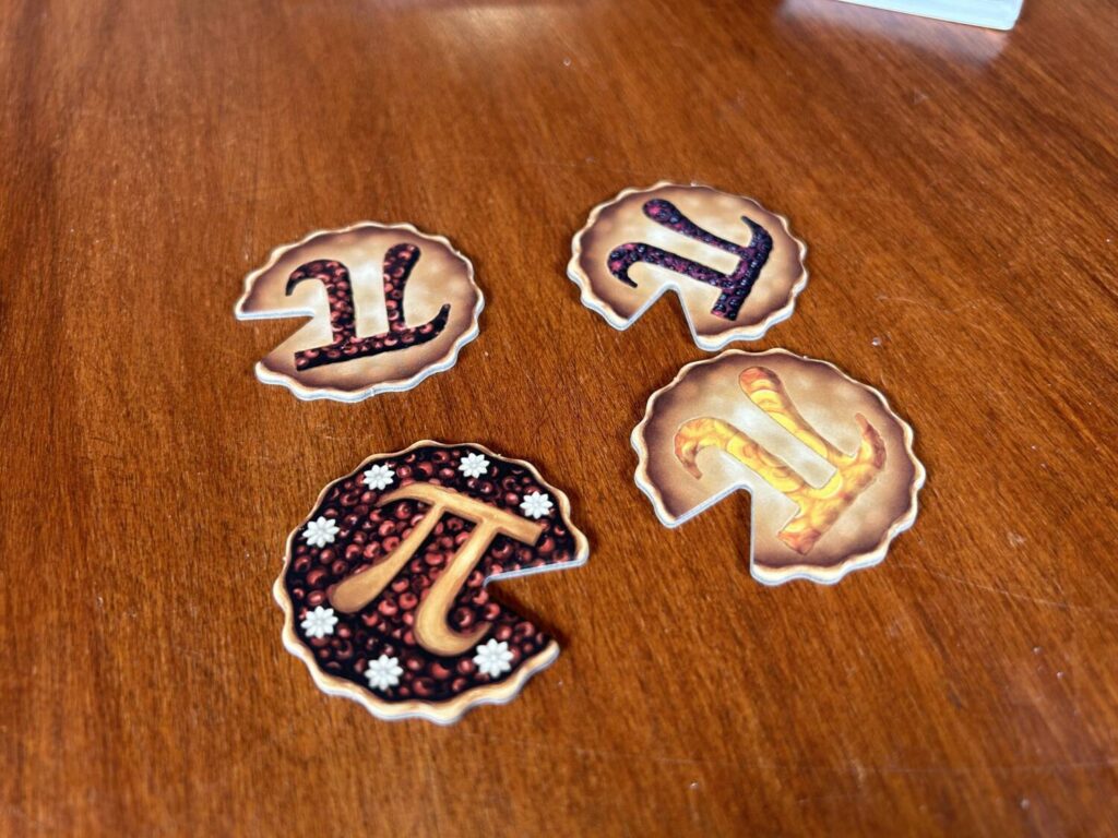 Pie-shaped tokens, with mathematical pi-shaped cuts in them. A hat on a hat.