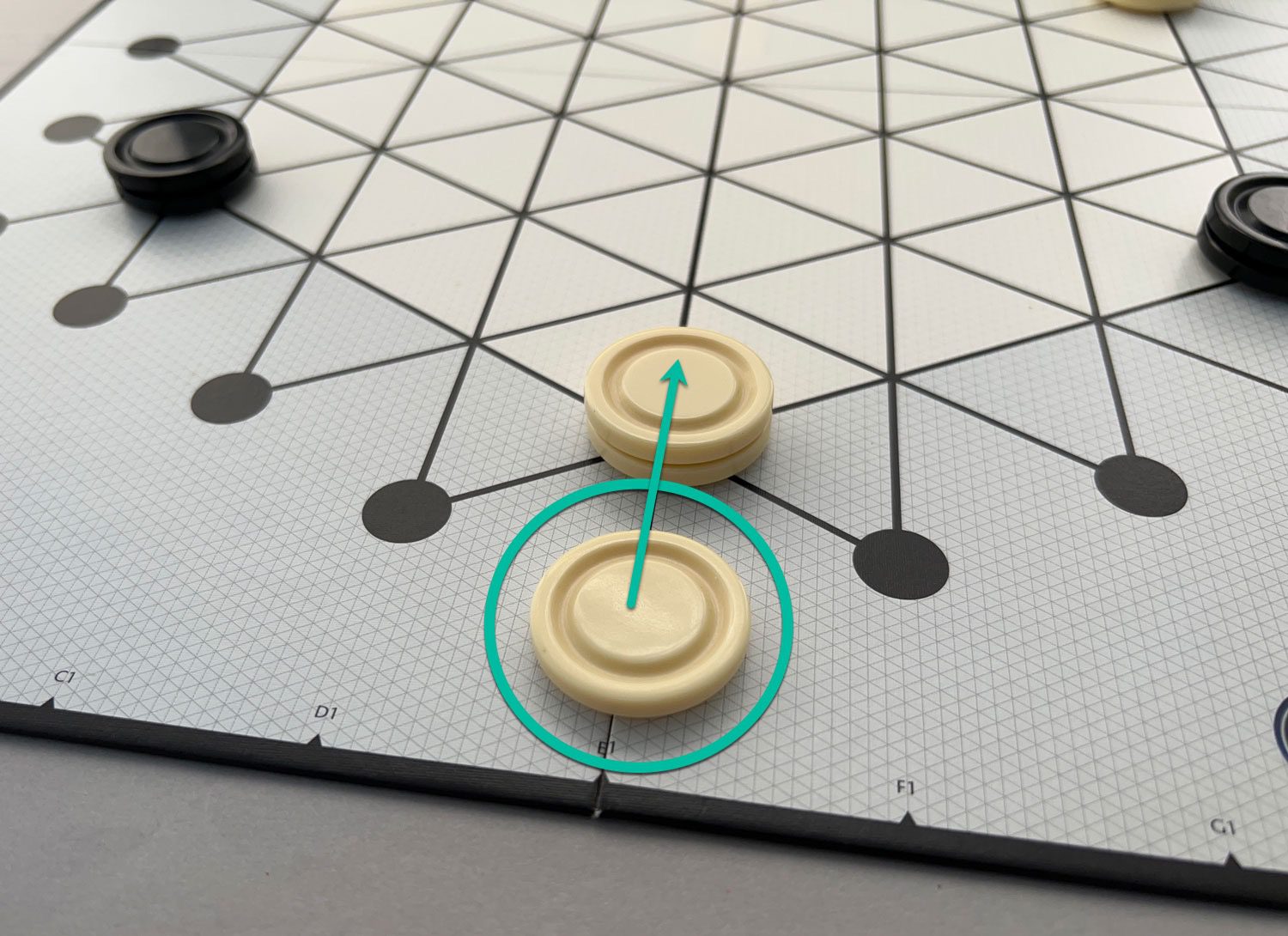 To push the white piece into the board, White places a piece on one of the connecting dots and pushes both pieces in a straight line