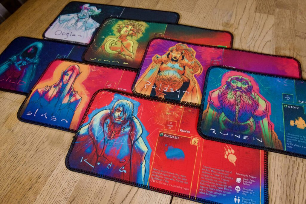 The seven faction boards, featuring boldly-colored illustrations from Trembley.