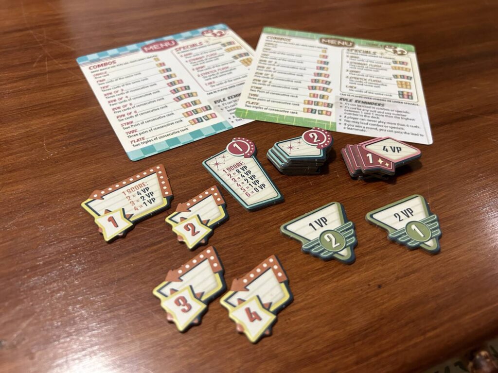 The game includes a number of tokens for scoring, depending on the number of players. All of them are designed to resemble the aesthetics of a 1950s diner sign.
