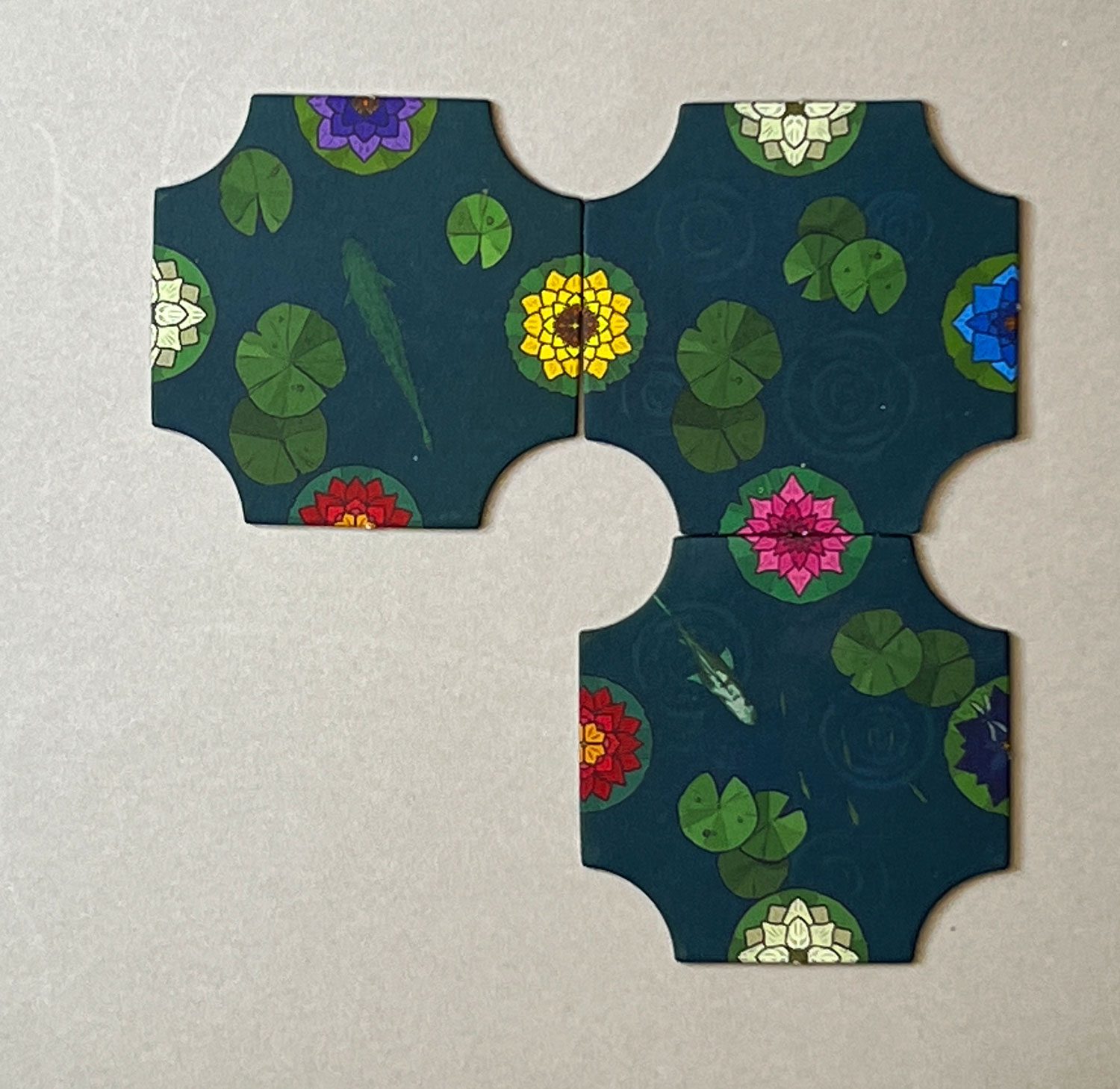 An example of a tile that does not exist: the fourth tile here would have to have a pair of the red lilies with a yellow center. None of the tiles have duplicates of a single lily.