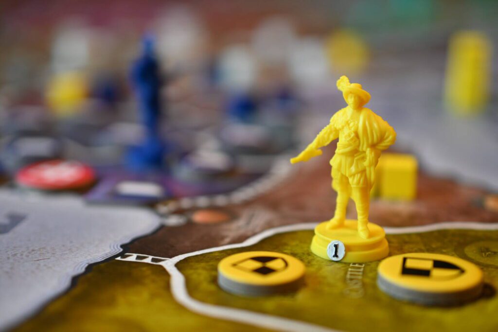 A yellow army marker, sculpted to resemble a military leader, stands guard in a Castilian province.