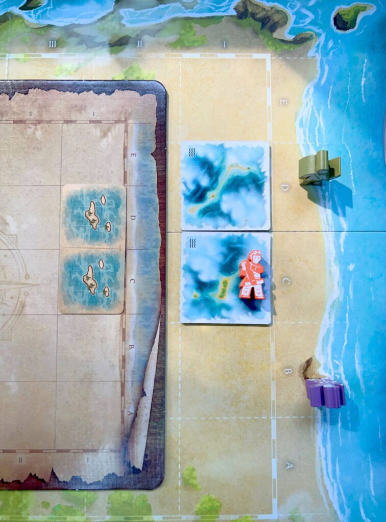 Two Unconfirmed Lagoon tiles. You'll place the Sketch card on your personal player map (shown here on the left) and two Lagoon tiles on the shared main board, misty side up. 