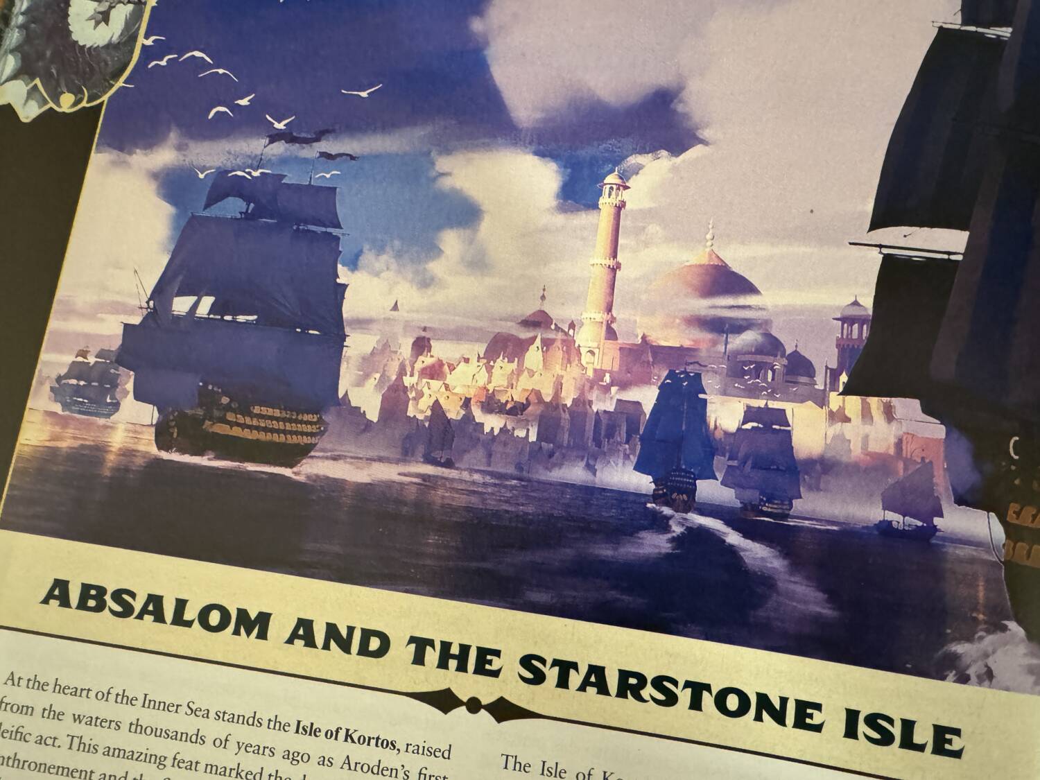 Pathfinder GM Core book open to show the Absalom and the Starstone Isle image of ships heading into Absalom's port.