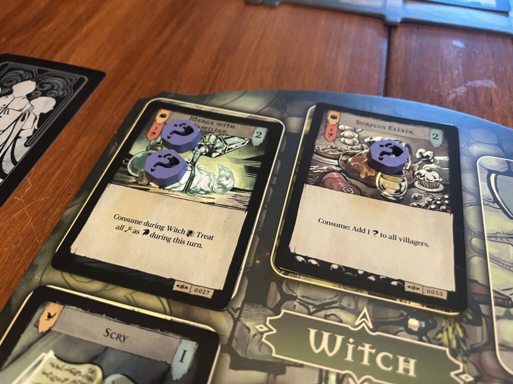 A close-up shot of the Witch's player board, with two potion cards.