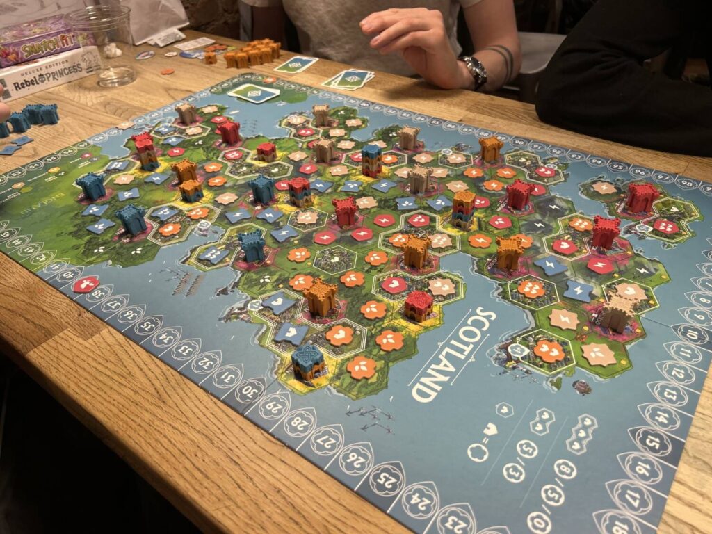 The board towards the end of a four-player game, full of tiles and castles.