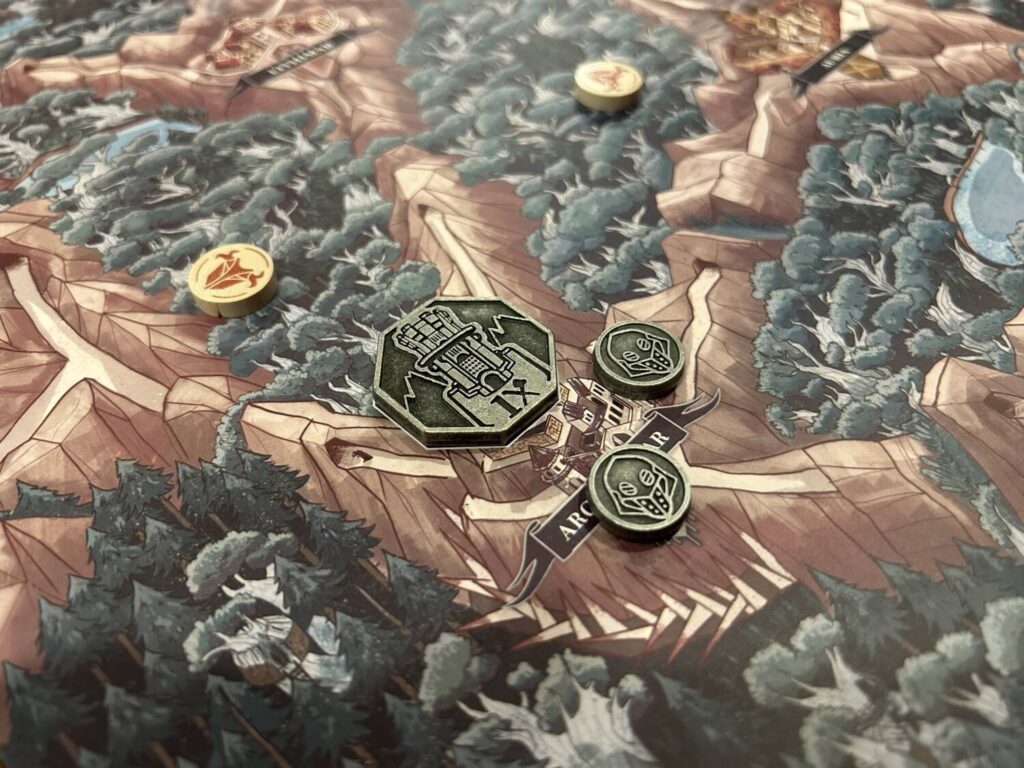 A close-up photo of some metallic pieces on the board. The Ironwalker tokens are octagonal, with heavy relief images.