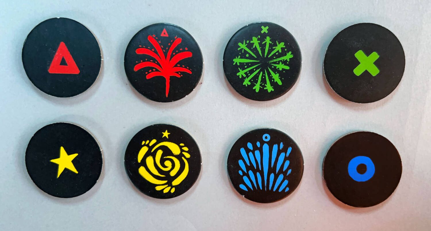 Firework tiles: the backs are to the far left and right; the fireworks themselves are the middle four. Note the colored icon above each firework