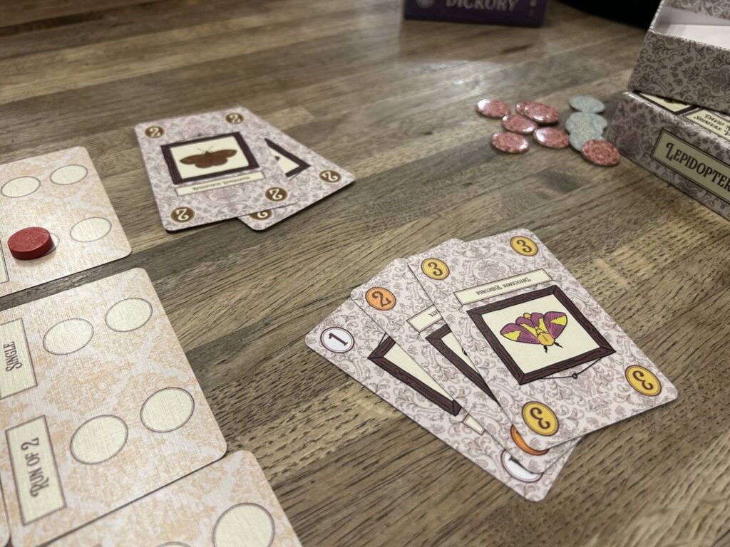 The cards for Lepidoptery include illustrations of various butterfly species. These add nothing thematically, but they are charming to look at.