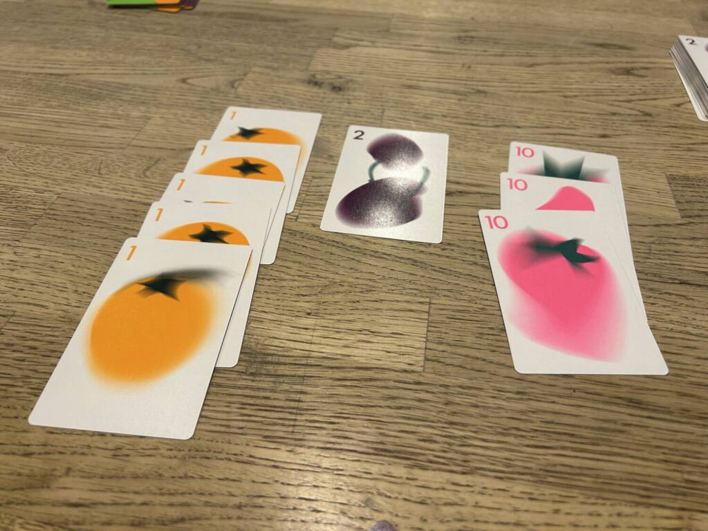 Three columns of Fruit Fight cards, each featuring impressionist illustrations of fruits.