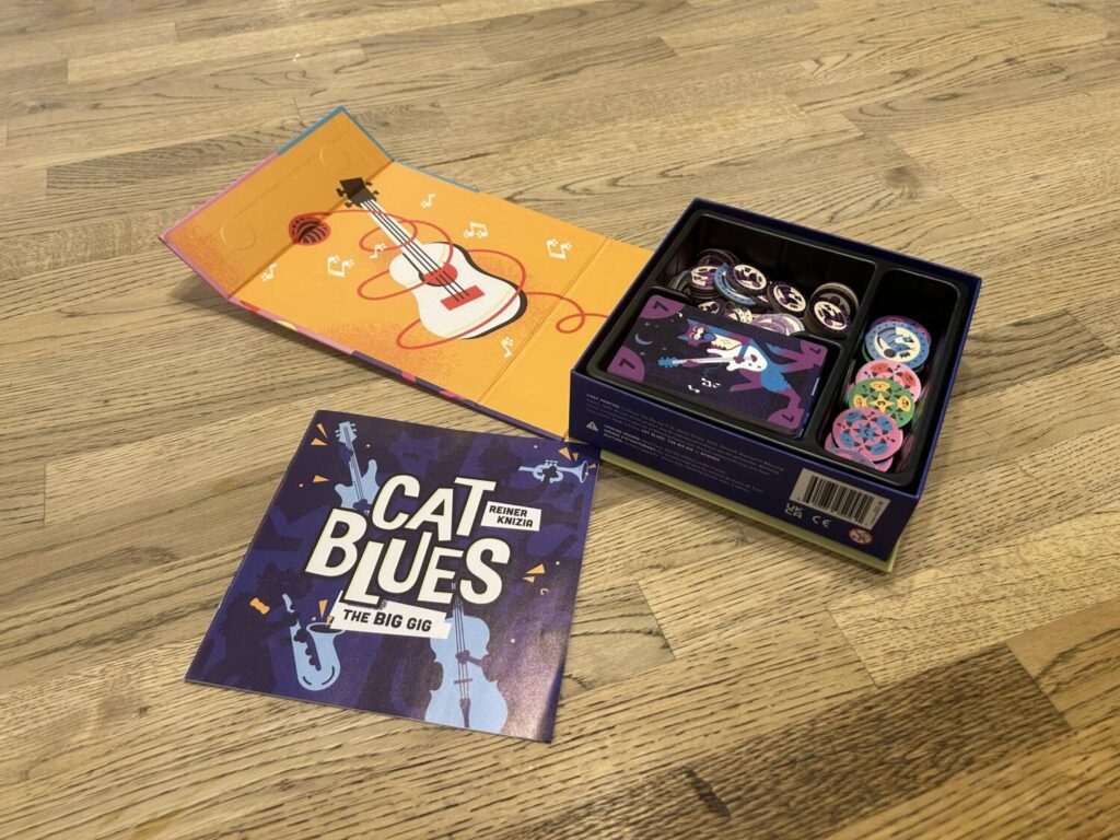 The inside of the box cover is a bright yellow illustration of a guitar.