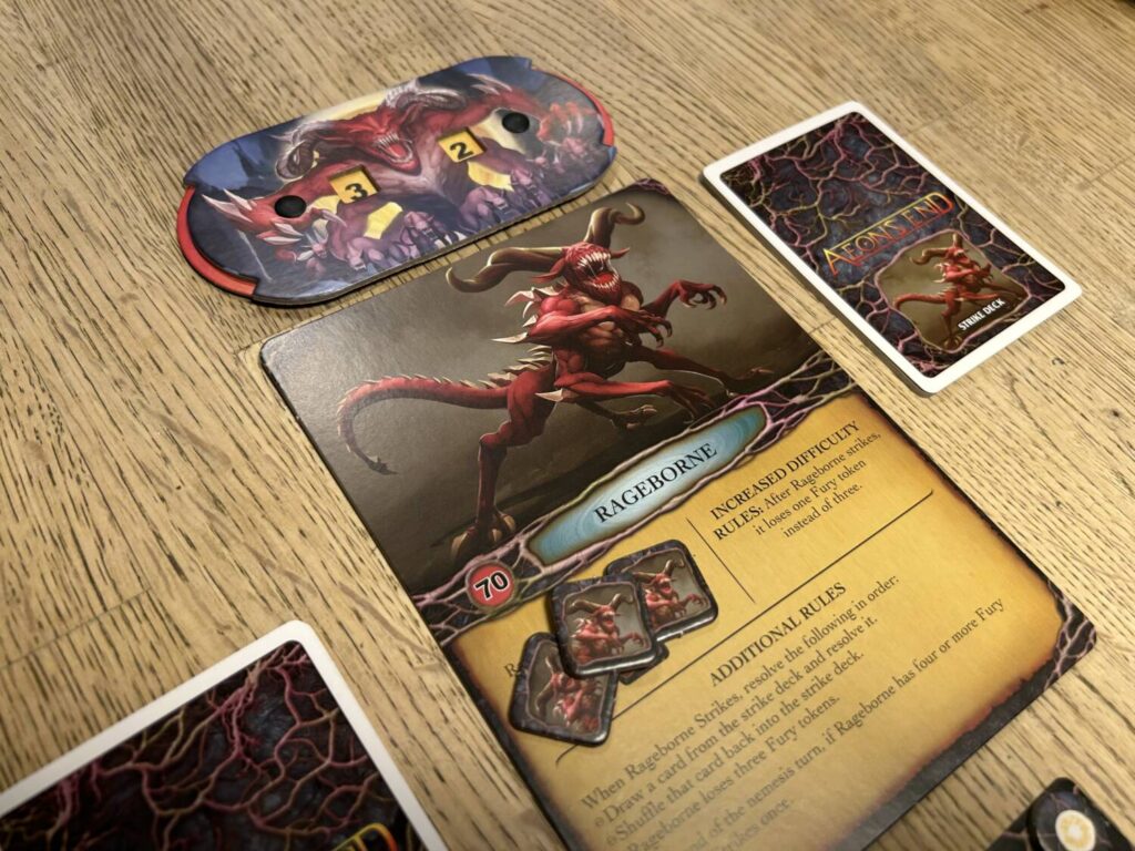 One of the Nameless boards, for Rageborne. An illustration of Rageborn, a red-scaled reptile-like creature with massive horns, occupies the top half of the board. Text instructions for executing his turns occupy the bottom half. A health dial can be seen above the board.