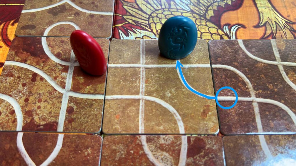 Blue playes the tile between blue and read. Blue moves along the blue line across the tile