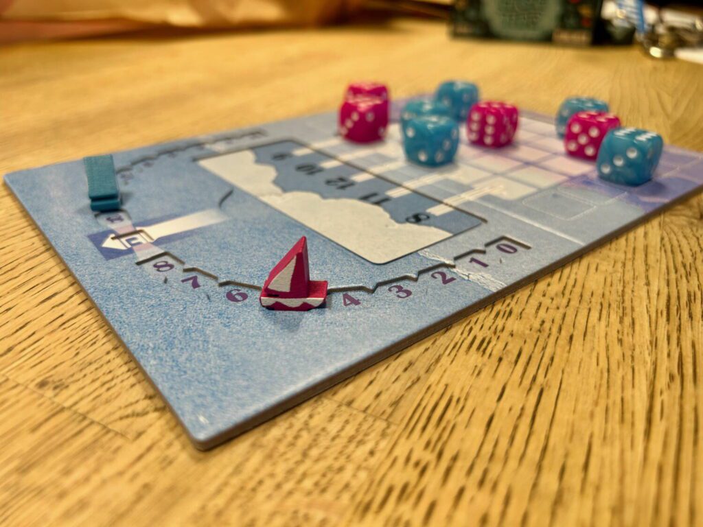 A close-up shot of a purple wooden boat on a scoring track.