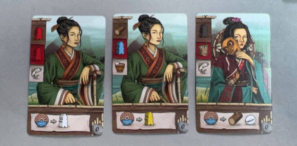 Villager cards are at thte heart of your actions each round. If you play a Villager face down, you'll receive the benefit in the upper left corner in the brown area. If you toss the card back in the box you'll get the brown and red supplies. If you tuck one of them under the board, you'll get the item(s) in white at the start of each round. (The goods in the left against a white background is part of another challenge you may be presented with during the game.)