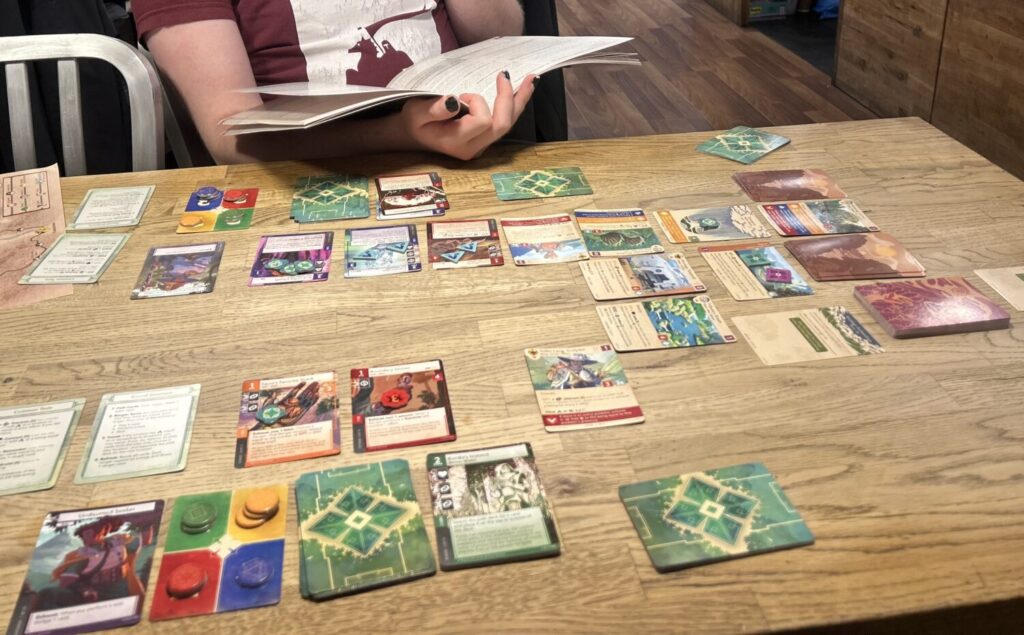 Many, many cards on a wooden table. So many cards.