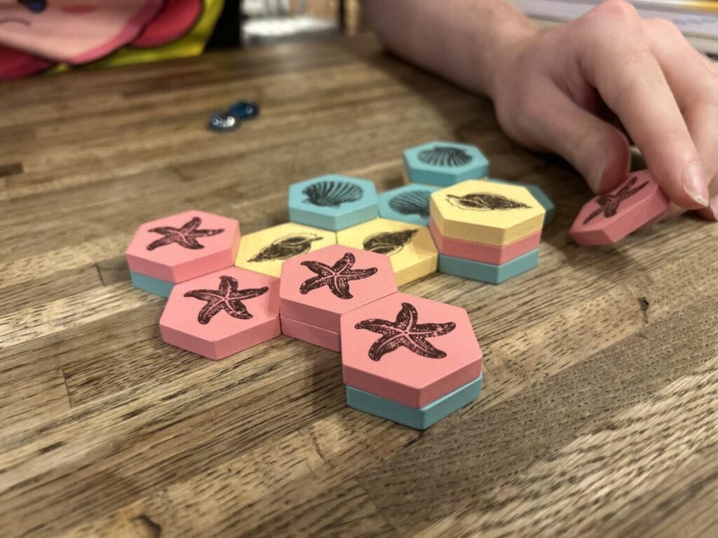 The board in the middle of a game, with stacks of anywhere between one and four tiles. The board as a whole is no longer a honeycomb shape.