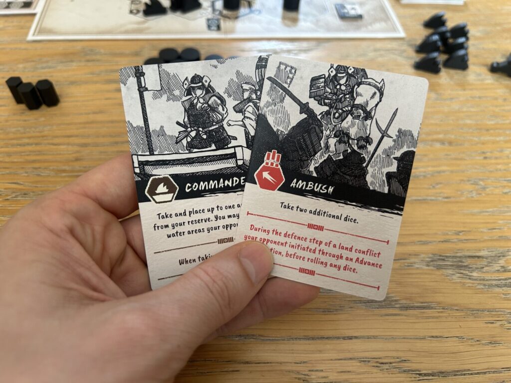 A close-up shot of two cards, each with a beautiful black-and-white illustration occupying the top half.