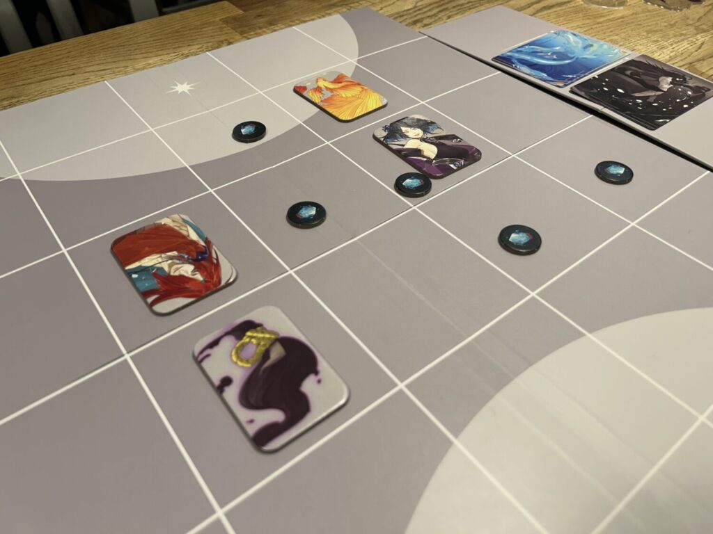 A photo nearly identical to the first photo, but the components are the standard cardboard tokens rather than the deluxe acrylic standees.