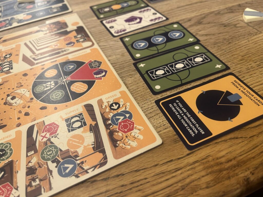 A set of five cards in a row on a wooden table.